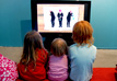 Children watching FABULERA MERA at the exhibition.